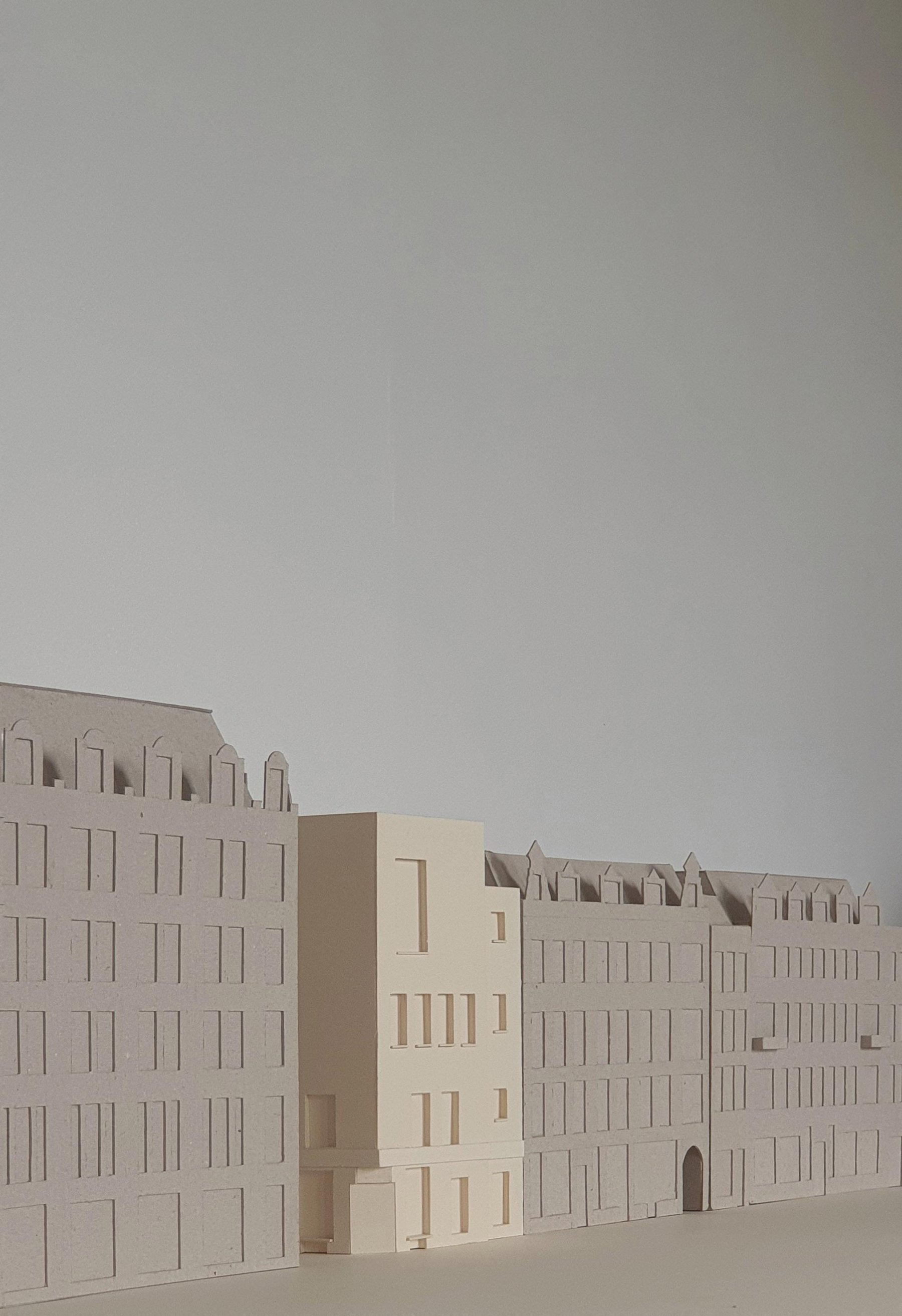 a 3d model with two brown buildings and one cream building