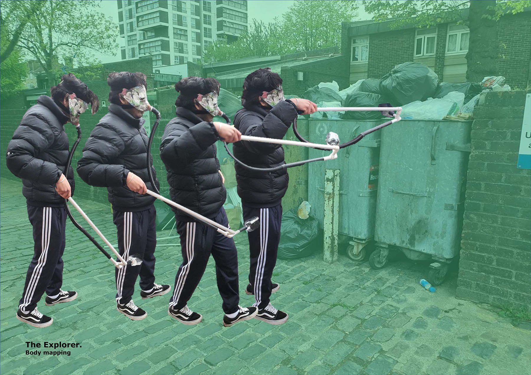 A person wearing a device that looks like a mask with a trunk-like tube attached to the mouth and a longer extension they use to pick up things from the floor. They are gathering garbage with it and throwing it in a bin