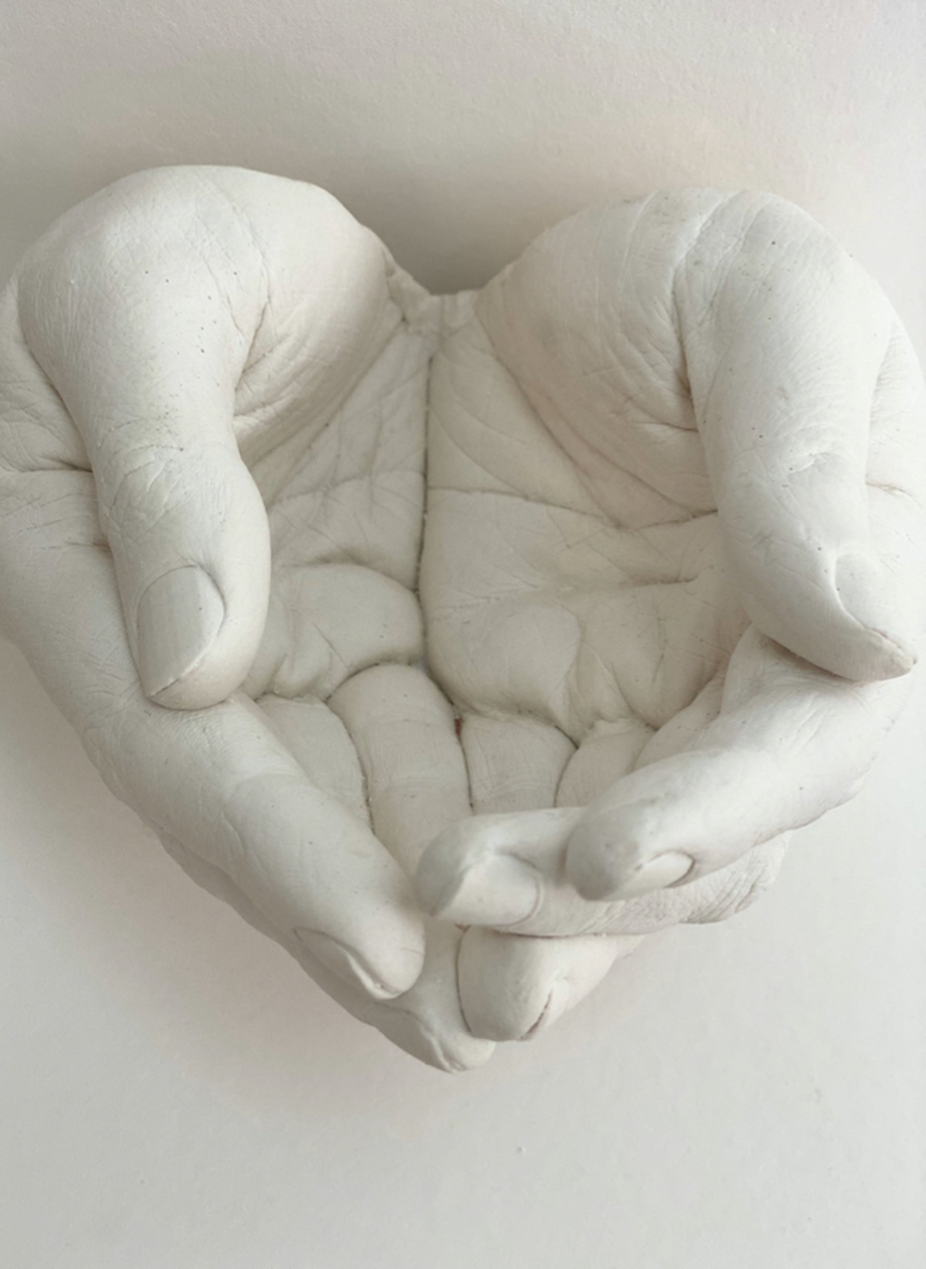 open hands cast in plaster