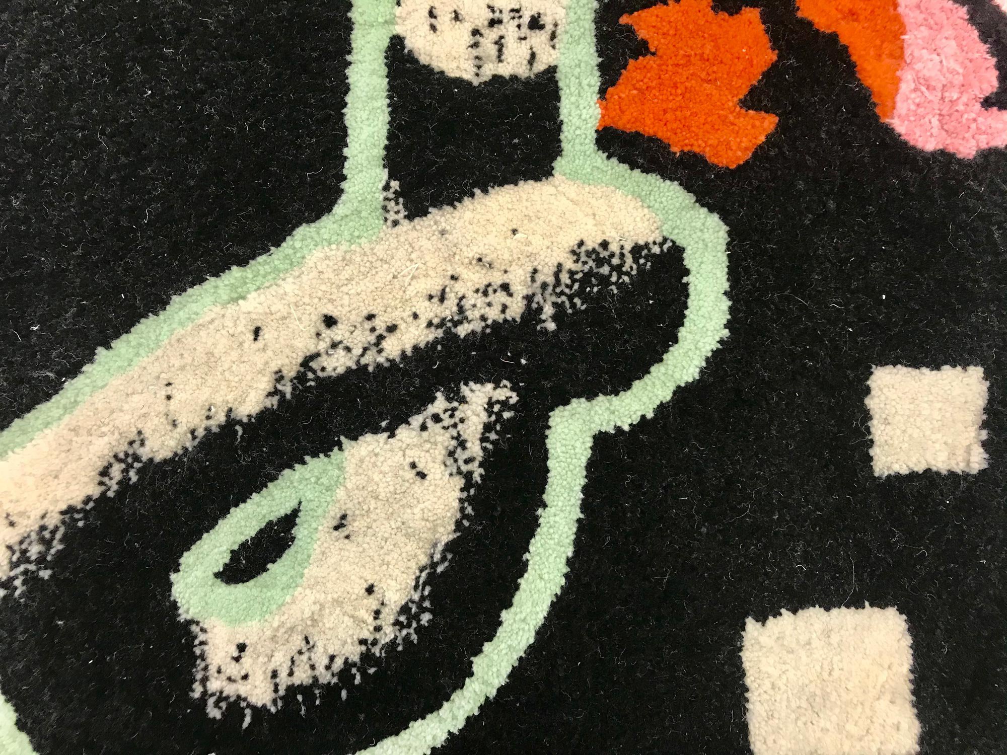 Detail of tufted rug in black and cream