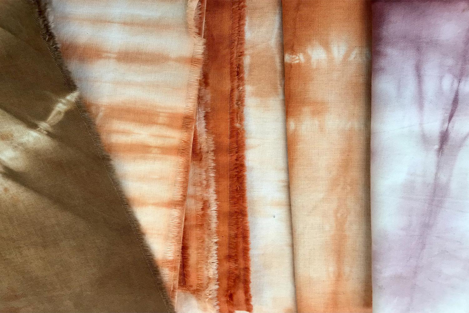 Resist dyed samples in pinks and rusts