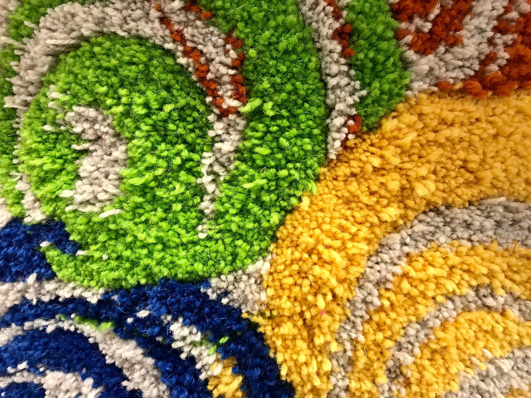 Detail of tufted rug in greens and yellows by Syeda Rahman